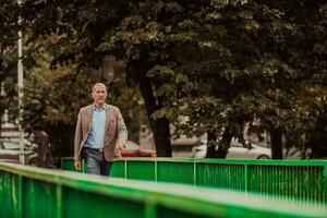 focused businessman in suit walking in urban environment. photo