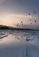 Pamukkale Travertines Cinematic Aerial Drone footage. Turkish famous white thermal bath with healthy clean water in a beautiful sunset. photo