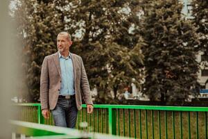 Focused businessman in a suit walking in the park photo