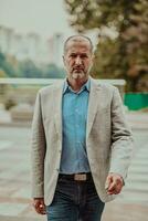 Focused businessman in a suit walking in the park photo