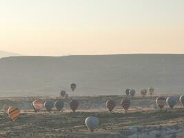 Aerial cinematic drone view of colorful hot air balloon flying over Cappadocia photo