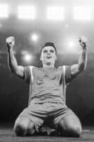 soccer player in front of big modern stadium with flares and lights photo