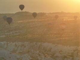 Aerial cinematic drone view of colorful hot air balloon flying over Cappadocia photo