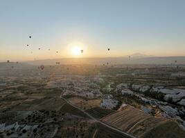 Aerial cinematic drone view of colorful hot air balloon flying over Cappadocia photo