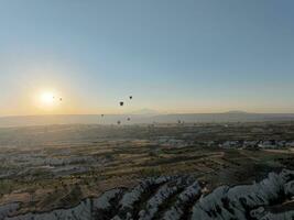Aerial cinematic drone view of colorful hot air balloon flying over Cappadocia photo