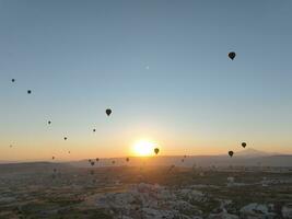 Aerial cinematic drone view of colorful hot air balloon flying over Cappadocia photo