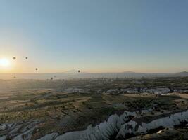 Aerial cinematic drone view of colorful hot air balloon flying over Cappadocia photo