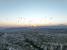 Aerial cinematic drone view of colorful hot air balloon flying over Cappadocia photo