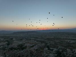 Aerial cinematic drone view of colorful hot air balloon flying over Cappadocia photo