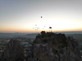 Aerial cinematic drone view of colorful hot air balloon flying over Cappadocia photo