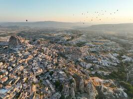 Aerial cinematic drone view of colorful hot air balloon flying over Cappadocia photo