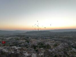Aerial cinematic drone view of colorful hot air balloon flying over Cappadocia photo