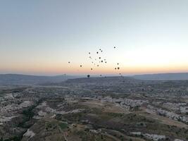 Aerial cinematic drone view of colorful hot air balloon flying over Cappadocia photo