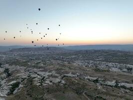 Aerial cinematic drone view of colorful hot air balloon flying over Cappadocia photo
