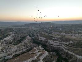 Aerial cinematic drone view of colorful hot air balloon flying over Cappadocia photo