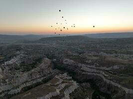 Aerial cinematic drone view of colorful hot air balloon flying over Cappadocia photo