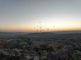 Aerial cinematic drone view of colorful hot air balloon flying over Cappadocia photo