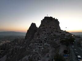 Aerial cinematic drone view of colorful hot air balloon flying over Cappadocia photo