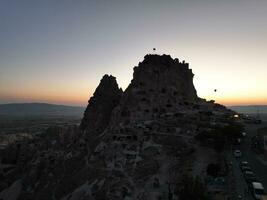 Aerial cinematic drone view of colorful hot air balloon flying over Cappadocia photo
