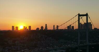 Istanbul Bosphorus Bridge and City Skyline in Background with Turkish Flag at Beautiful Sunset, Aerial slide orbiting and tracking shot photo