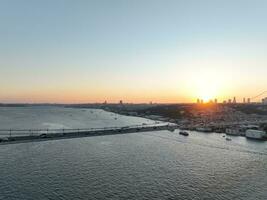 Istanbul Bosphorus Bridge and City Skyline in Background with Turkish Flag at Beautiful Sunset, Aerial slide orbiting and tracking shot photo