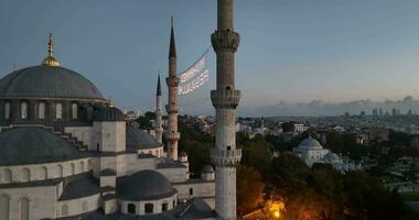 Istanbul, Turkey. Sultanahmet with the Blue Mosque and the Hagia Sophia with a Golden Horn on the background at sunrise. Cinematic Aerial view. photo