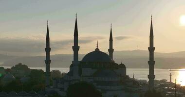 Istanbul, Turkey. Sultanahmet with the Blue Mosque and the Hagia Sophia with a Golden Horn on the background at sunrise. Cinematic Aerial view. photo