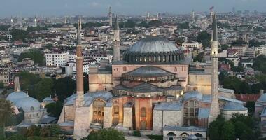 Istanbul, Turkey. Sultanahmet with the Blue Mosque and the Hagia Sophia with a Golden Horn on the background at sunrise. Cinematic Aerial view. photo