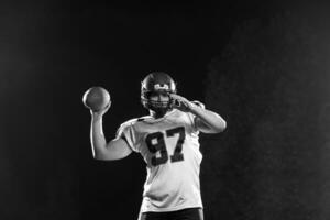 american football player throwing rugby ball photo