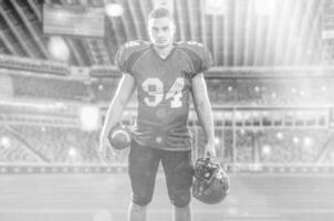 American Football Player isolated on big modern stadium field photo