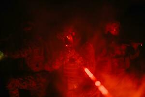 Soldiers squad in action on night mission using laser sight beam lights military team concept photo