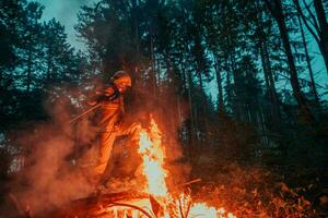 firefighter hero in action danger jumping over fire flame to rescue and save photo