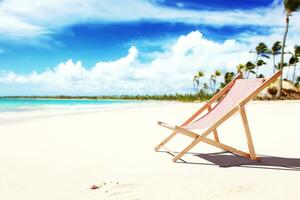 Relax on tropical beach in the sun on deck chairs. photo