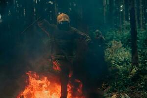 firefighter hero in action danger jumping over fire flame to rescue and save photo