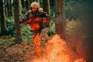 Soldier in Action at Night in the Forest Area. Night Time Military Mission jumping over fire photo