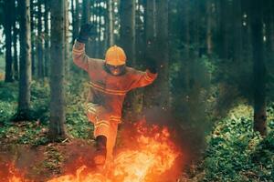 firefighter hero in action danger jumping over fire flame to rescue and save photo