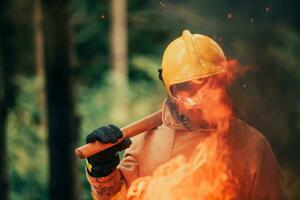 Firefighter at job. Firefighter in dangerous forest areas surrounded by strong fire. Concept of the work of the fire service photo