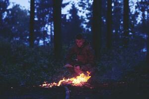 soldiers resting by fire in forest photo