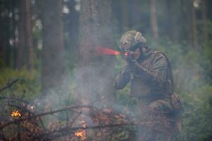 soldier in action aiming  on weapon  laser sight optics photo