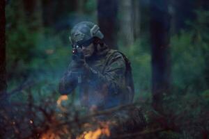 soldier in action aiming  on weapon  laser sight optics photo