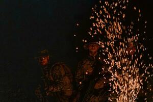 Soldiers squad in action on night mission using laser sight beam lights military team concept photo