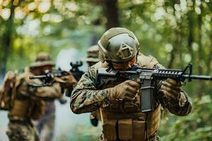 A group of modern warfare soldiers is fighting a war in dangerous remote forest areas. A group of soldiers is fighting on the enemy line with modern weapons. The concept of warfare and military conflicts photo