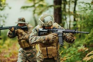 A group of modern warfare soldiers is fighting a war in dangerous remote forest areas. A group of soldiers is fighting on the enemy line with modern weapons. The concept of warfare and military conflicts photo