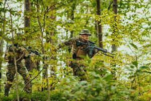 A modern warfare soldier on war duty in dense and dangerous forest areas. Dangerous military rescue operations photo