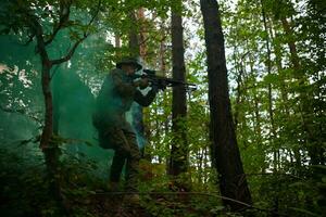 soldier in action aiming  on weapon  laser sight optics photo