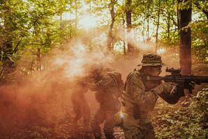 A group of modern warfare soldiers is fighting a war in dangerous remote forest areas. A group of soldiers is fighting on the enemy line with modern weapons. The concept of warfare and military conflicts photo