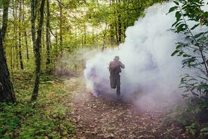 Battle of the military in the war. Military troops in the smoke photo