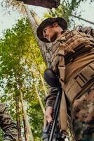 Soldier portrait with protective army tactical gear and weapon having a break and relaxing photo