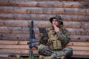 soldier using tablet computer in military camp photo