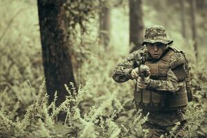 un moderno guerra soldado en guerra deber en denso y peligroso bosque áreas peligroso militar rescate operaciones foto